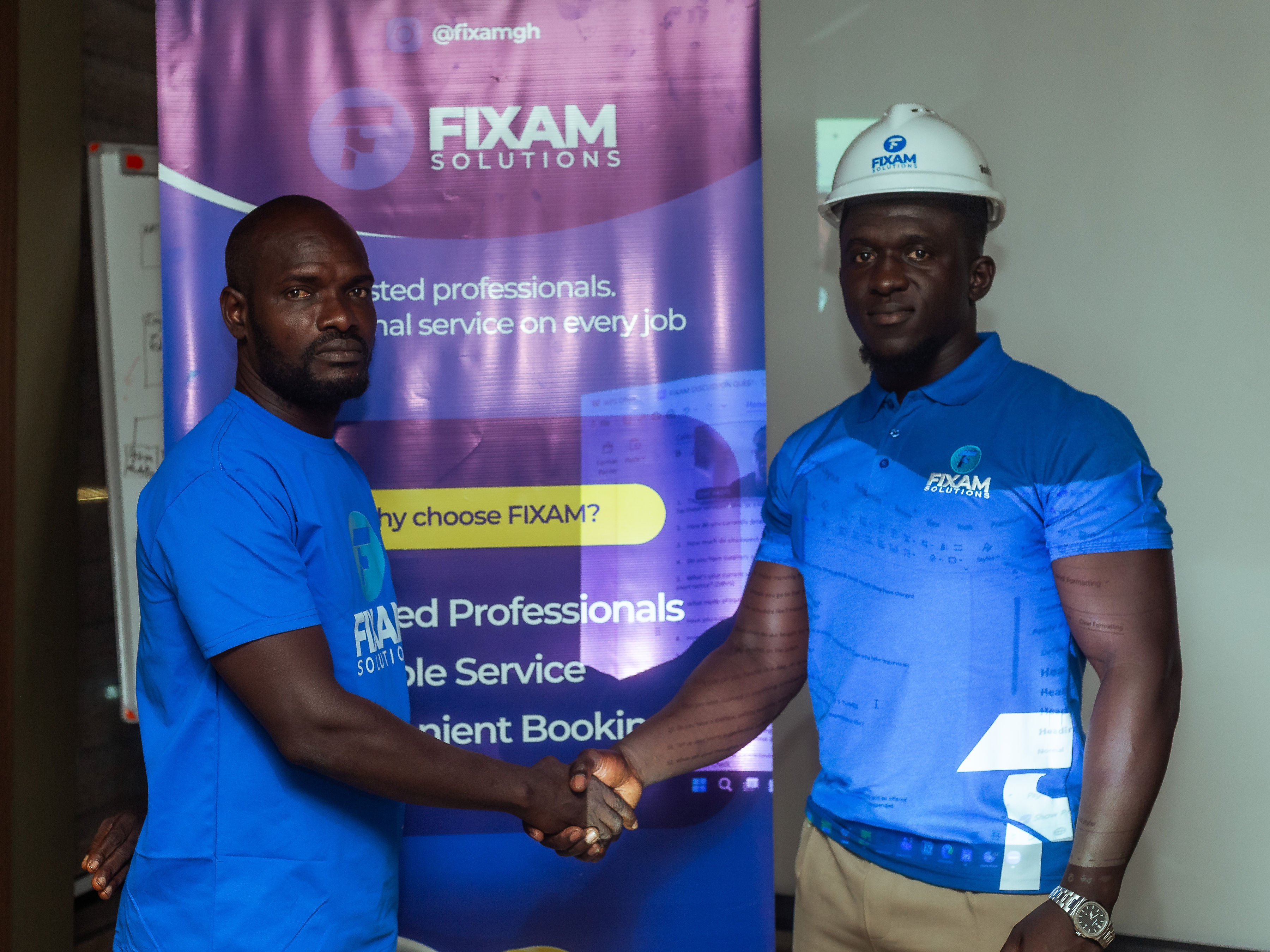 Two FIXAM team members shaking hands